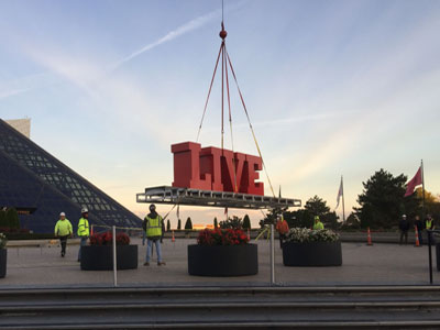 Installation of lettering for the Long Live Rock display at the Rock & Roll Hall of Fame